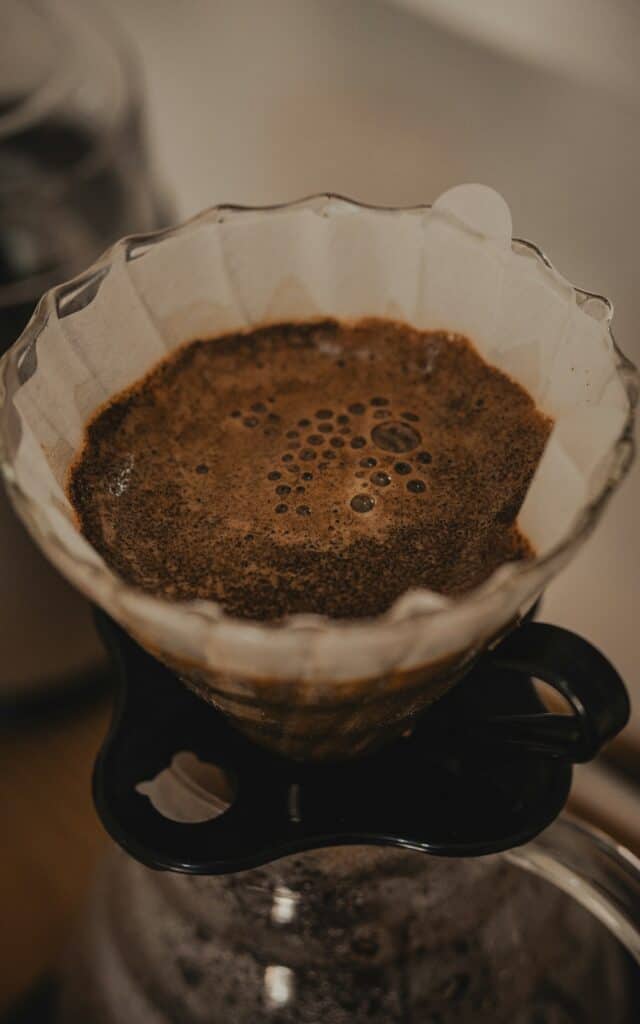 Ground coffee blooming in a paper filter