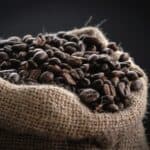 Coffee beans spilling from a burlap sack