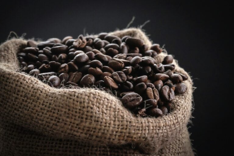 Coffee beans spilling from a burlap sack