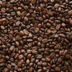 Roasted espresso beans on a dark surface