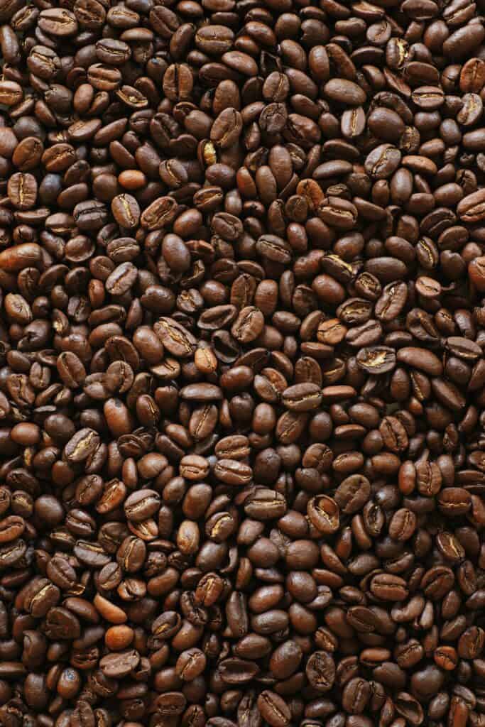 Roasted espresso beans on a dark surface