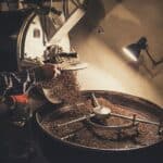 Beans tumbling in the drum of a coffee roaster