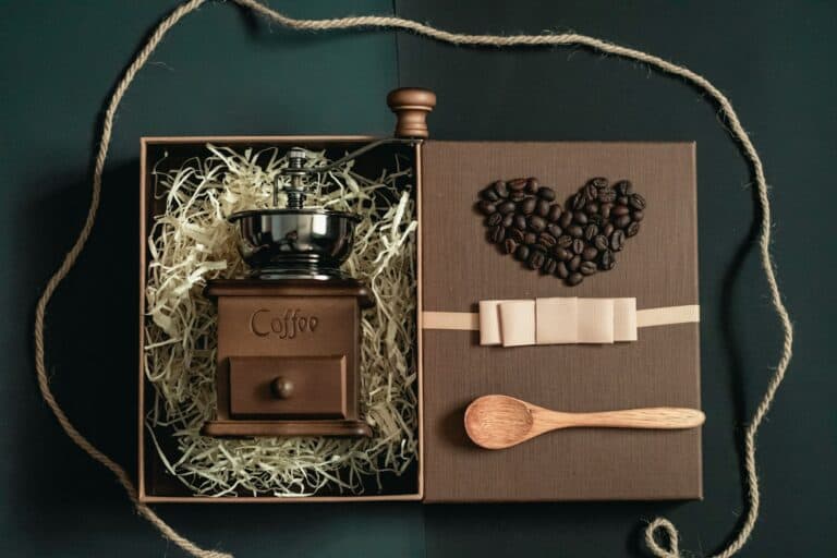 A gift box holding a hand grinder and loose beans