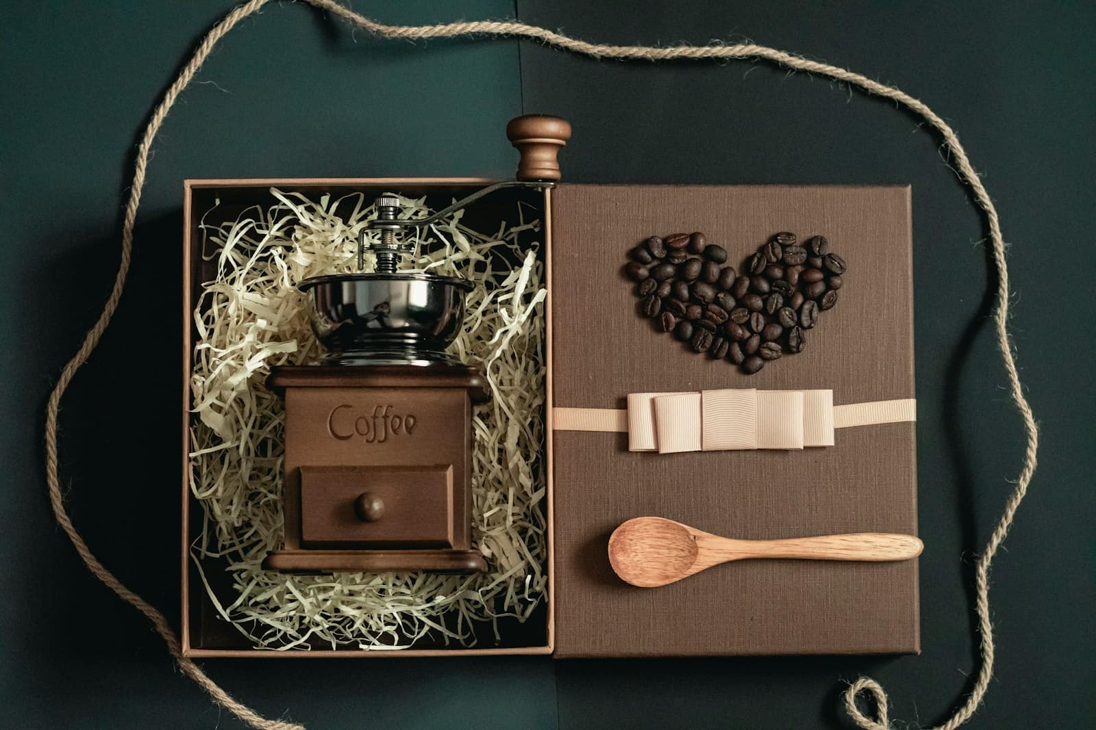 A gift box holding a hand grinder and loose beans