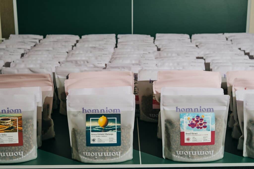 Bags of freshly roasted coffee lined up on a shelf