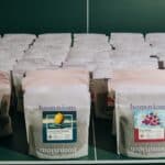 Bags of freshly roasted coffee lined up on a shelf