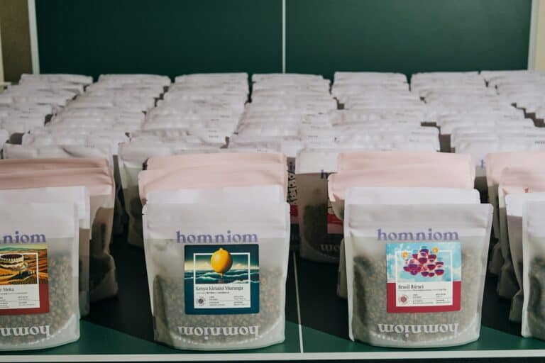 Bags of freshly roasted coffee lined up on a shelf