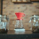A ceramic dripper sitting on a brewing scale