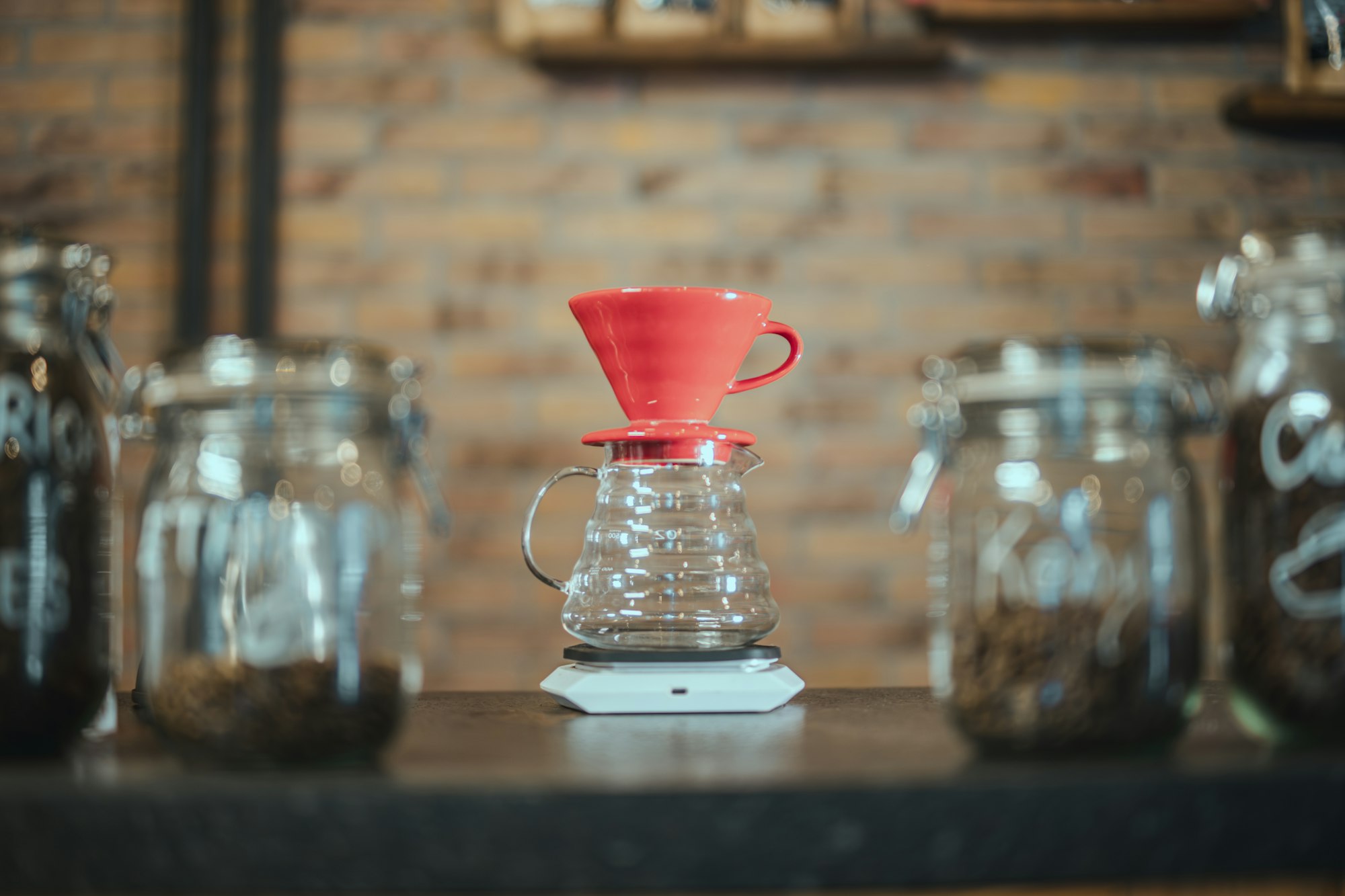 A ceramic dripper sitting on a brewing scale